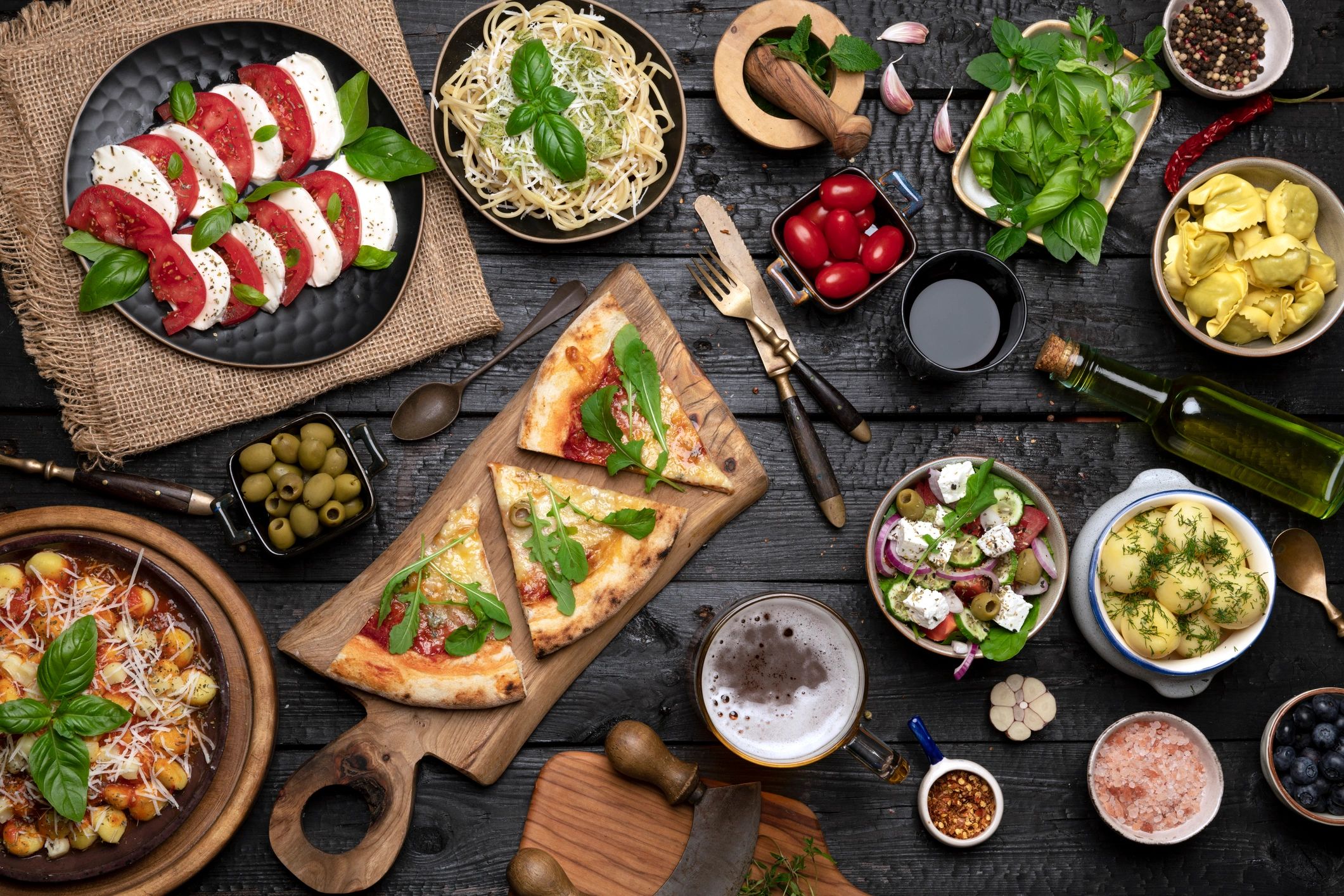 Italian dining table with pizzas and pasta